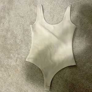 Cute light beige body suit that is slimming